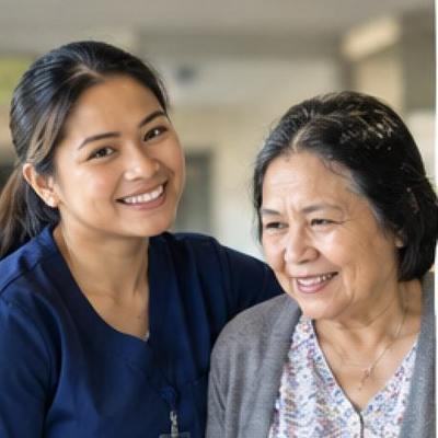 A MapleBridge caregiver walking with a client at home