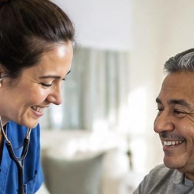 A nurse checking a client's blood pressure at home