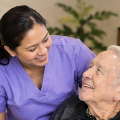 A caregiver with a client in a wheelchair